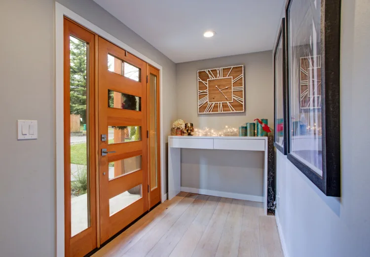 Entry of a home with a modernized door with simulated divided panels.